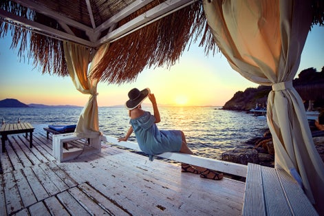 Photo of tourist relaxing by the sea and sunset enjoying perfect beach holiday vacation in Bodrum.