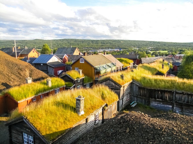 photo of view of Traditional wooden houses with peat on the roof in the village of Roros, Norway.