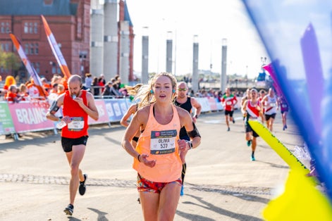 Cardiff Half Marathon. Roald Dahl Plass, runners raise money for charity cheered on by crowds of supporters.