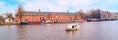 photo of Hermitage Amsterdam traditional old buildings, canal and boat view in Amsterdam, The Netherlands.