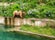 Photo of a Bear is walking along edge of pool in Bern Bear Pit (Barengraben) in Bern Bear Park, Berne, Switzerland.