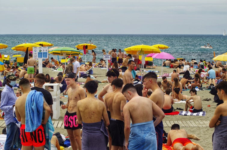 Ostia, Rome, Italy, many young people on a free beach.