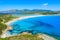 Photo of aerial view of a beautiful bay with azure sea from top of a hill, Villasimius, Sardinia island, Italy.