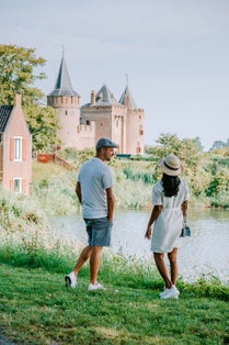 photo of Muiderslot castle near Amsterdam - Netherlands, Muideslot during summer in the Netherlands. Europe couple visiting Muiderslot on a trip.
