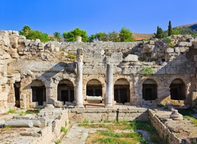 Photo of temple of Apollo with Acrocorinth in the background. Ancient Corinth, Greece.