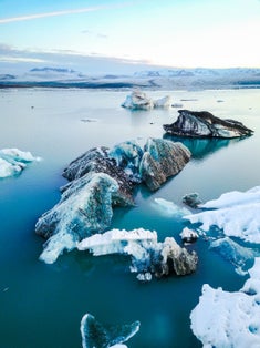 photo of aerial view of amazing glacier patterns and shapes in jokulsarlon lake, Iceland. Glacial lagoon with icebergs floating. Climate change, global warming, melting glacier.