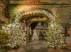 Photo of scenic summer view of the German traditional medieval half-timbered Old Town architecture and bridge over Pegnitz river in Nuremberg, Germany.