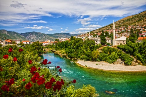 photo of view of Mostar, Bosnia and Herzegovina. Morning sun on Nerteva River and Old City of Mostar, Bosnia and Herzegovina.