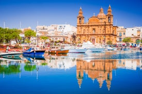 Photo of Msida Marina boat and church reflection into water, Malta.