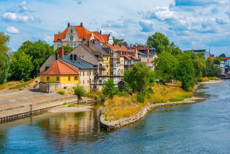 Colorful houses at waterfront of Danube river in Regensburg, Germany.