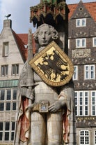 Photo of beautiful panoramic view of historic Bremen Market Square in the center of the Hanseatic City of Bremen with The Schuetting and famous Raths buildings on a sunny day with blue sky in summer, Germany.