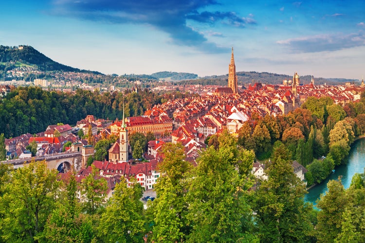 Photo of old town of Bern, capital of Switzerland, covered with colorful sunrise.