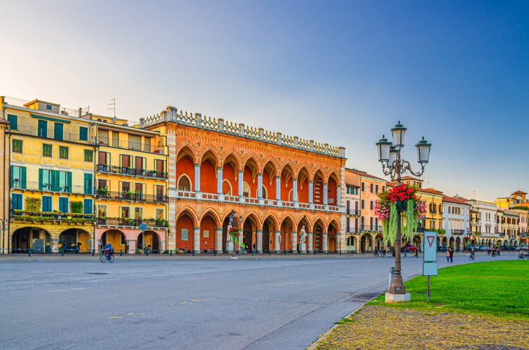 photo of view Padua cityscape with Palazzo Loggia Amulea palace neogothic style building and street lights on Piazza Prato della Valle square in historical city centre, Padova town, Veneto Region, Italy.