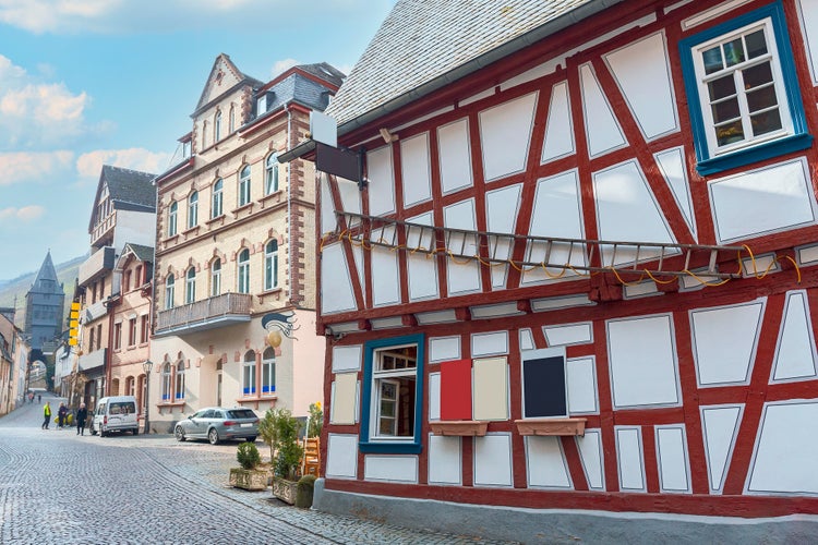 view of a stone-paved street with a beautiful half-timbered house in the old German town of Braubach,Germany