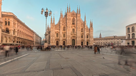 photo of Panorama showing Milan Cathedral and historic buildings timelapse during sunset. Duomo di Milano is the cathedral church located at the Piazza del Duomo square in Milan city in Italy