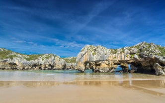 Photo of Ballota beach with the islet Castro, Llanes,  Spain.