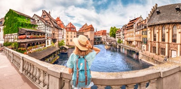 Photo of traditional half-timbered houses on picturesque canals in La Petite France in the medieval fairytale town of Strasbourg, France.