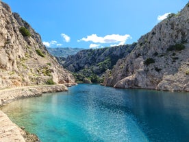 photo of  Pláž Senj it's a small beach hidden by vegetation near the Adriatic Sea, Senj, Croatia.