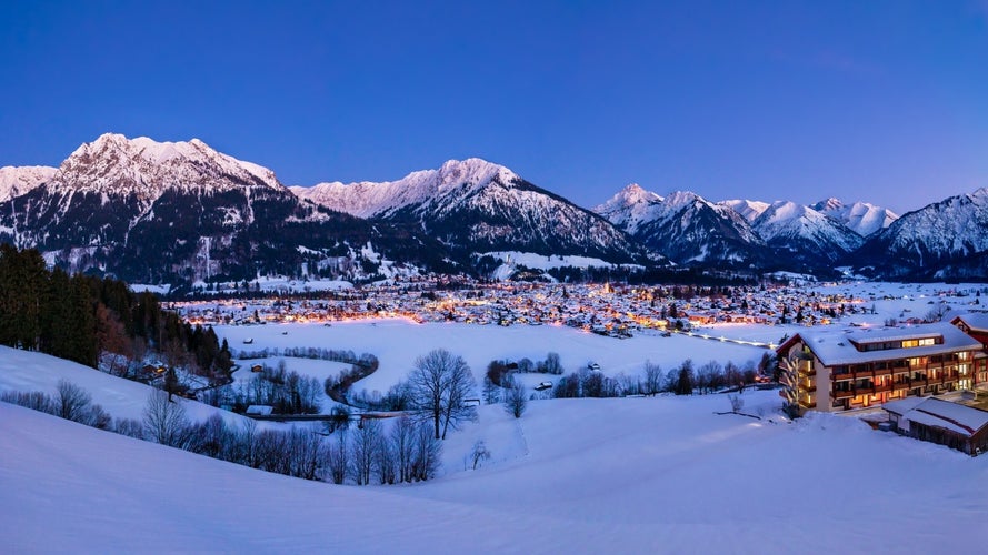 photo of the valley Kleinwalsertal and Oberstdorf, Germany, with Alps in the winter with snow covered landscape in the evening.