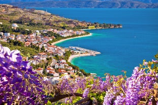 Photo of panorama and landscape of Makarska resort and its harbour with boats and blue sea water, Croatia.