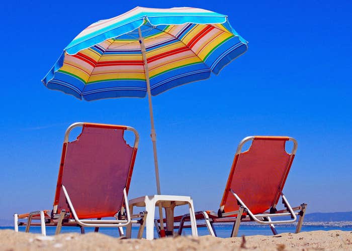 Photo of beautiful beach of Peraia with sunbeds and umbrellas, suburbs of Thessaloniki, Greece.