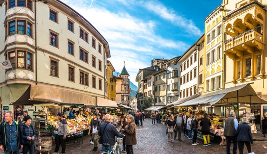 photo of view of Bolzano, italy - October 19: People shopping at a famous Market Square in the old town at october 19,2018 in Bolzano in Italy.