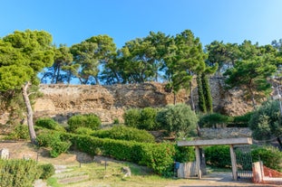 Photo of temple of Apollo with Acrocorinth in the background. Ancient Corinth, Greece.