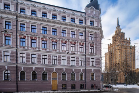 Winter cityscape of Riga. Modern architecture. Snow on road. Cloudy sky. Latvian Academy of Sciences