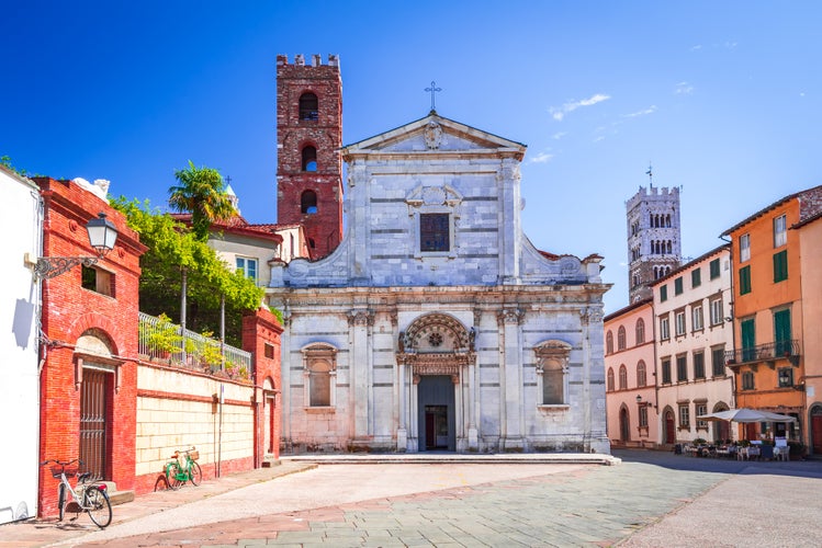 photo of view of Lucca, Italy - View of Piazza San Giovanni and famous St Martin Cathedral tower in background, postcard of Tuscany.