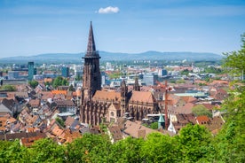 Photo of aerial view of the historic city center of Freiburg im Breisgau from famous old Freiburger Minster in beautiful evening light at sunset, Germany.