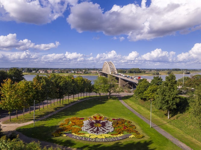 Bridge over the river Waal in Nijmegen, Holland with park and coat of arms of the city in flowers