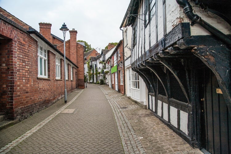 Photo of old passage street with black and white half timbered buildings St marys passage in Stafford, UK.