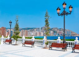 Photo of aerial panoramic view coastline and La Vila Joiosa Villajoyosa touristic resort townscape, sandy beach and Mediterranean seascape, Costa Blanca, Spain.