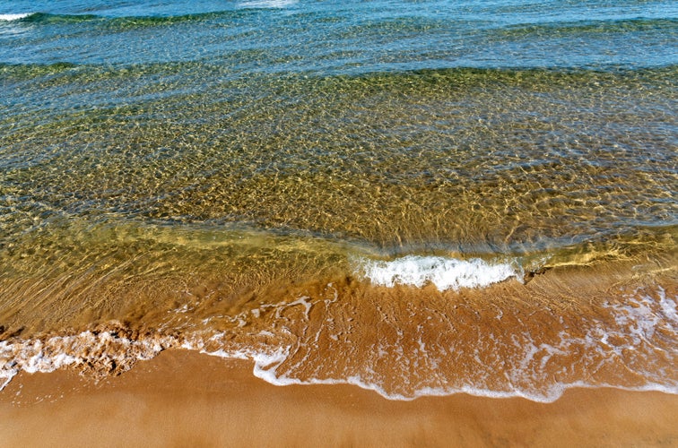 Photo of colourful sea with waves breaking on the Ambrosia Beach at Gournes.