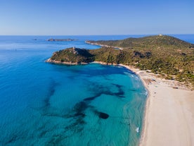 Photo of aerial view of a beautiful bay with azure sea from top of a hill, Villasimius, Sardinia island, Italy.