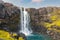 photo of view of Beautiful view of Gufufoss waterfall flowing thourgh rocks in summer at Seydisfjordur, East of Iceland.