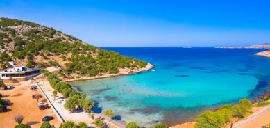 Photo of panoramic aerial view of the popular Platis Gialos beach on the Greek island of Mykonos with turquoise sea, Greece.