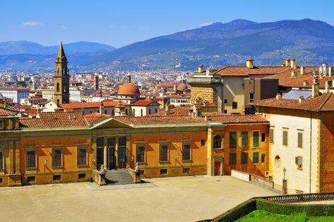 photo of skyline of the city and back view of Palazzo Pitti, facing Boboli Gardens, in Florence, Italy .