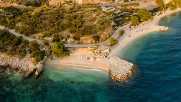 Photo of panorama and landscape of Makarska resort and its harbour with boats and blue sea water, Croatia.