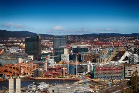 Photo of landscape with mountains, river and buildings in Lillehammer town, Norway.