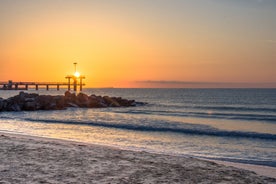 Photo of Saint Anastasia Island in Burgas bay, Black Sea, Bulgaria. Lighthouse tower and old wooden buildings on rocky coast.