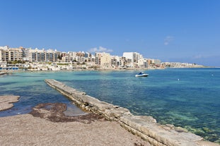 Photo of Seaside cliffs, colourful houses and streets of Qawra town in St. Paul's Bay area in the Northern Region, Malta.