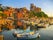 Boats of Lerici docked in Lerici port and famous Italian Gulf of Poets. San Giorgio castle on the background at sunset. La Spezia province, Ligurian Coast of Italy.