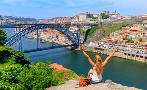 Porto, Portugal old town ribeira aerial promenade view with colorful houses, Douro river and boats.