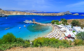 Photo of panoramic aerial view of Lindos bay, village and Acropolis, Rhodes, Greece.