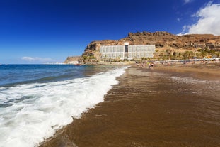 photo of landscape with Maspalomas town and golden sand dunes at sunrise, Gran Canaria, Canary Islands, Spain.