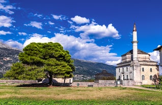 photo of green slopes surrounding the mountain town of Arachova near Parnassus Mountains, Greece.