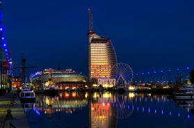 Photo of aerial view of the city of Bremerhaven with the harbor and traditional sailing-ships, Germany.