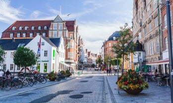 Scenic summer view of Nyhavn pier with color buildings, ships, yachts and other boats in the Old Town of Copenhagen, Denmark