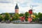 photo of panoramic cityscape from a sailing boat. Yacht marina, cathedral, traditional houses, windmill. Strängnäs, Mälaren lake, Sweden.